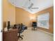 Well-lit home office with ample desk space, rolling chairs, and wood floors at 2721 Day Lily Run, The Villages, FL 32162
