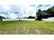 A lush green backyard is completely enclosed by a pristine white privacy fence at 2883 Sw 146Th Place Rd, Ocala, FL 34473