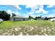 Spacious backyard featuring a home and lush green grass surrounded by a privacy fence at 2883 Sw 146Th Place Rd, Ocala, FL 34473