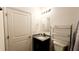 Bathroom featuring granite sink, chrome fixtures and storage shelves at 2883 Sw 146Th Place Rd, Ocala, FL 34473