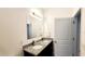 Bathroom featuring a double vanity with granite countertop, modern fixtures, and large mirror at 2883 Sw 146Th Place Rd, Ocala, FL 34473