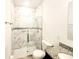 Bathroom showcasing a tiled shower with glass door, toilet, and granite vanity at 2883 Sw 146Th Place Rd, Ocala, FL 34473