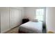 A cozy bedroom with a twin bed features a window, tile floor, and closet at 2883 Sw 146Th Place Rd, Ocala, FL 34473