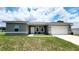 Charming one-story home featuring a well-manicured lawn and an attached two-car garage at 2883 Sw 146Th Place Rd, Ocala, FL 34473