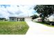 Charming single-story home featuring a well-manicured lawn, a gray exterior, and an attached two-car garage at 2883 Sw 146Th Place Rd, Ocala, FL 34473