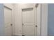 Hallway featuring three doors and neutral paint at 2883 Sw 146Th Place Rd, Ocala, FL 34473