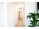 Hallway featuring tile flooring and white walls leading to various rooms at 2883 Sw 146Th Place Rd, Ocala, FL 34473