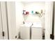 Bright laundry room with washer, dryer, and storage shelf at 2883 Sw 146Th Place Rd, Ocala, FL 34473