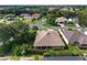 Overhead angle showcases the roof and the home's backyard with mature trees and landscaping at 3001 Hillside Ln, The Villages, FL 32162