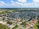 Expansive aerial view showcasing a well-maintained neighborhood with lush green spaces at 3001 Hillside Ln, The Villages, FL 32162