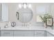 Well-lit bathroom featuring a vanity with sleek countertop, decorative plant, and minimalist decor at 3001 Hillside Ln, The Villages, FL 32162