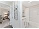 Bathroom featuring bathtub with shower, and views into the decorated bedroom at 3001 Hillside Ln, The Villages, FL 32162