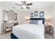Serene bedroom with elegant decor, featuring a blue upholstered bed frame and stylish side tables at 3001 Hillside Ln, The Villages, FL 32162