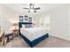Cozy bedroom with blue accents, plantation shutters, and a ceiling fan at 3001 Hillside Ln, The Villages, FL 32162