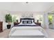 Primary bedroom with a ceiling fan, shuttered windows, and sliding glass doors to the lanai at 3001 Hillside Ln, The Villages, FL 32162
