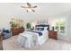 Bedroom with a ceiling fan, large mirror, shuttered windows, and dark wood bedroom furniture at 3001 Hillside Ln, The Villages, FL 32162