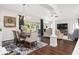 Open dining and living area with hardwood floors, chandelier, and sliding glass doors to a patio at 3001 Hillside Ln, The Villages, FL 32162