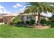 Well-maintained home with lush landscaping, mature palm trees, and a manicured lawn in a desirable location at 3001 Hillside Ln, The Villages, FL 32162