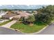 Well-manicured lawn and mature trees surround this inviting home at 3001 Hillside Ln, The Villages, FL 32162