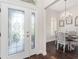 Home foyer featuring decorative glass front door, hardwood floors, and a view of the dining room at 3001 Hillside Ln, The Villages, FL 32162