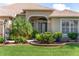 Charming home exterior featuring a beautifully landscaped front yard and inviting entryway with decorative glass at 3001 Hillside Ln, The Villages, FL 32162
