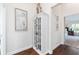 Hallway with decorative cabinet with glass doors, statuette, and a print of a heron at 3001 Hillside Ln, The Villages, FL 32162