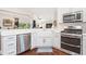 Modern kitchen with stainless appliances, farmhouse sink and open layout to living area at 3001 Hillside Ln, The Villages, FL 32162