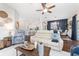 Cozy living room with stylish decor, hardwood floors, and an open layout to the kitchen at 3001 Hillside Ln, The Villages, FL 32162