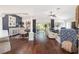 Open-concept living and dining area with hardwood floors and sliding glass doors to the outdoors at 3001 Hillside Ln, The Villages, FL 32162