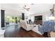 Bright living room featuring hardwood floors, large sliding glass doors, and comfortable seating arrangement at 3001 Hillside Ln, The Villages, FL 32162