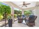 Relaxing screened patio with ceiling fan and comfortable seating, perfect for enjoying the outdoors at 3001 Hillside Ln, The Villages, FL 32162