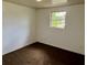 This bedroom features a large window allowing natural lighting throughout at 3801 Sw 147Th Lane Rd, Ocala, FL 34473