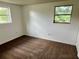This bedroom features two large windows allowing natural lighting throughout at 3801 Sw 147Th Lane Rd, Ocala, FL 34473