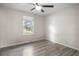 Bright bedroom with neutral walls, wood floors, and a large window allowing natural light at 42 Almond Dr, Ocala, FL 34472