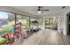 Bright sunroom with large windows offering serene views of the backyard and nature at 42 Almond Dr, Ocala, FL 34472