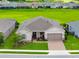 Aerial view of a well-maintained single Gathering home with lush green surroundings in a quiet, residential neighborhood at 4419 Nw 54Th Ter, Ocala, FL 34482