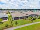 Aerial view of a home with a large, green backyard, neighboring houses, and a walking path at 4419 Nw 54Th Ter, Ocala, FL 34482