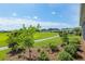 Expansive backyard view, featuring a lush green lawn, a walking path, and neighborhood homes in the distance at 4419 Nw 54Th Ter, Ocala, FL 34482