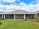 Spacious backyard with a covered patio, well-maintained lawn, and beautifully arranged landscaping at 4419 Nw 54Th Ter, Ocala, FL 34482