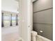Adjacent to the bedroom, find a half-bath with a toilet, a dark-painted accent wall, and wood-look tile at 4419 Nw 54Th Ter, Ocala, FL 34482