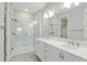 Bathroom featuring double sinks, a tiled shower, and modern lighting fixtures at 4419 Nw 54Th Ter, Ocala, FL 34482