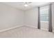 Inviting bedroom with soft carpeting, a ceiling fan, and a window offering natural light at 4419 Nw 54Th Ter, Ocala, FL 34482