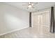 Bedroom with tile floor and large entry to another room with a ceiling fan at 4419 Nw 54Th Ter, Ocala, FL 34482
