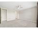 Spacious carpeted bedroom with a ceiling fan, base trim, and bathroom access at 4419 Nw 54Th Ter, Ocala, FL 34482