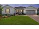 Charming single Gathering home with a well-manicured lawn and neutral exterior paint, accented by decorative stone elements at 4419 Nw 54Th Ter, Ocala, FL 34482