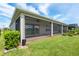 The screened in lanai has ceiling fans and a view of the lawn at 4419 Nw 54Th Ter, Ocala, FL 34482