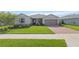 Lovely home exterior featuring a well-kept lawn, brick driveway, and inviting front entrance at 4419 Nw 54Th Ter, Ocala, FL 34482