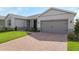 A well-maintained one story single Gathering home with a brick paver driveway, and lush landscaping at 4419 Nw 54Th Ter, Ocala, FL 34482