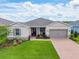 Attractive home exterior with a green lawn, brick driveway, and beautiful landscaping at 4419 Nw 54Th Ter, Ocala, FL 34482