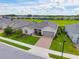 A well-manicured lawn complements this home's neutral facade, accented by a brick driveway and matching gray trim at 4419 Nw 54Th Ter, Ocala, FL 34482